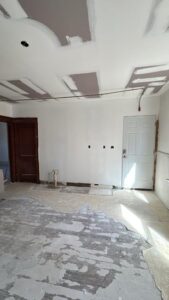 Initial stage of the kitchen renovation with stripped floors and unfinished walls