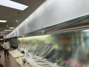 supermarket wall painting area protected with plastic covering before painting.