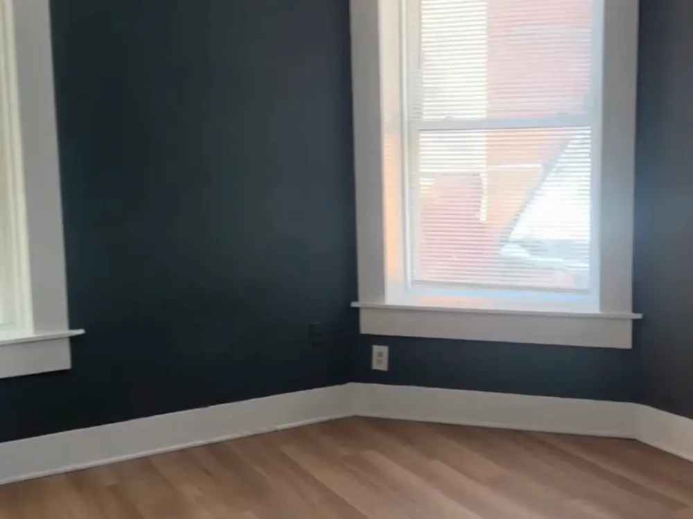 Apartment interior painting showing freshly painted living area with neutral wall color