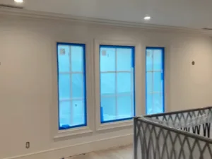 Interior residential renovation finishing with painted doors and protected flooring